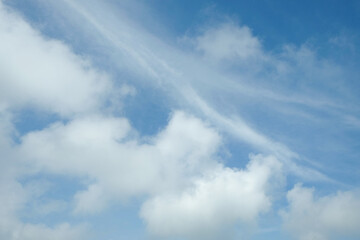 Bright blue daytime sky pattern and texture background with fluffy white clouds. Climate and weather concept. For graphic design, banner background and 3d rendering