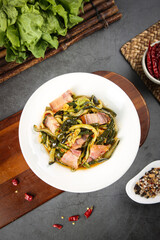 Asian Kelp Seaweed Stir-Fry with Pork Strips and Fresh Vegetables on Dark Slate Kitchen Counter