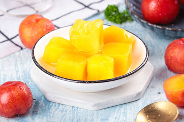 Fresh Yellow Plum Slices from Guangdong Province with Red Plums on Wooden Background