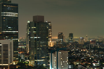 Naklejka premium Night cityscape of Jakarta with modern high rise buildings 