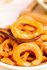 Spicy Squid Rings on Wooden Spoon - Golden Fried Seafood Close-Up