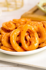 Spicy Marinated Squid Rings Cooked Seafood Appetizer on White Plate