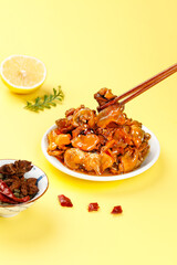 Spicy Glazed Squid with Chopsticks on Yellow Background - Asian Seafood Dish