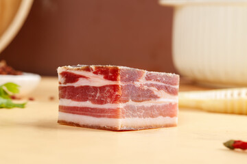 Raw Bacon Block with Fat Marbling on Wooden Cutting Board - Fresh Pork Belly Meat for Cooking