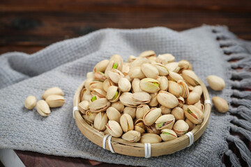 Roasted Pistachios with Green Kernels in Bamboo Bowl - Healthy Nuts Snack