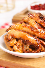 Spicy Marinated Calamari Tentacles Seafood Appetizer on White Plate