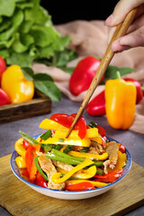 Shandong Pork Stir Fry with Colorful Bell Peppers and Fresh Vegetables in Traditional Bowl