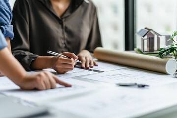 Interior architect planning project with blueprint in modern workplace