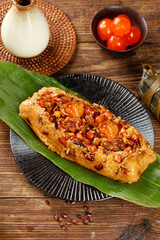 Guangxi Style Rice Dumplings with Salted Egg Yolk and Meat on Banana Leaf - Traditional Chinese Zongzi Cuisine