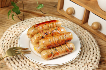 Grilled Herb Sausages on White Plate with Golden Fork and Rustic Wooden Kitchen Setting