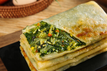 Homemade Savory Pastry with Eggs Leeks and Vermicelli on Wooden Board Traditional Breakfast