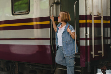Woman traveler at train station awaiting journey