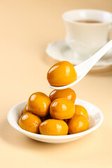 Golden Preserved Quail Eggs Traditional Delicacy with Tea Cup Food Photography