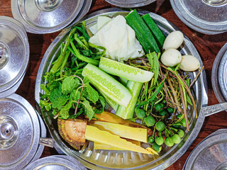Top view of various vegetables is placed in a stainless steel bowl to be eaten with Burmese shrimp...