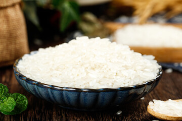 Professional studio shot of white rice in ceramic bowl with mint garnish closeup