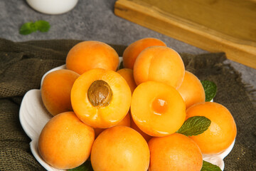 Fresh Organic Apricots with Mint Leaves on White Plate - Healthy Stone Fruit Food Photography