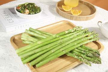 Fresh Green Asparagus Spears on Wooden Board with Prepared Dish - Healthy Vegetable Food Photography