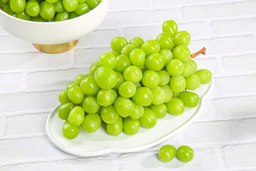 Fresh Green Grapes on White Plate - Healthy Organic Fruit on Rustic Wooden Background