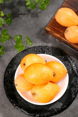 Fresh Sichuan Loquat Fruits on Plate - Traditional Chinese Fruit Display with Natural Food Styling