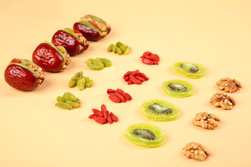 Red Xinjiang Dates Stuffed with Walnuts and Assorted Dried Fruits Healthy Snack Mix on Neutral Background