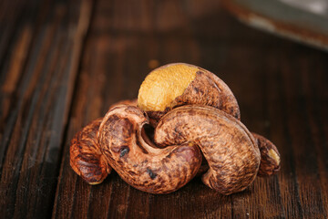 Purple Coated Dried Cashews with Crunchy Kernels on Wooden Background - Healthy Nut Snack Food Photography