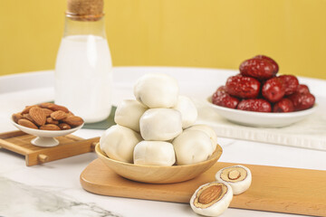 Handmade White Cheese Balls with Dates Almonds and Milk on Wooden Board Traditional Homemade Dairy Food Preparation