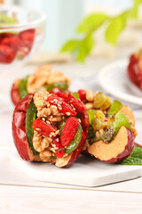 Xinjiang Red Dates Stuffed with Walnuts and Dried Fruits Traditional Chinese Healthy Snack on White Plate