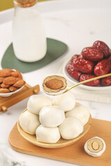 Handmade Fresh Cheese with Dates and Almonds on Wooden Board - Artisanal Dairy Snack Platter