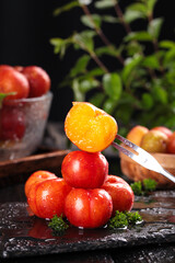Fresh Red Plums with Golden Slice on Fork - Crisp Juicy Fruit Display with Water Droplets