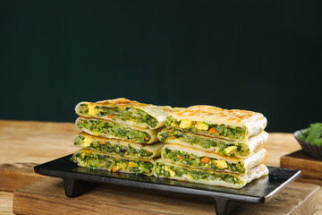 Fresh Handmade Savory Pancakes with Leek and Vegetable Filling on Black Plate - Healthy Breakfast