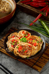 Mongolian Lamb Stuffed Bread Rolls with Red Peppers and Herbs on Cast Iron Plate - Traditional Asian Cuisine