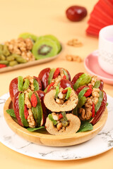 Xinjiang Dried Fruits with Red Dates and Walnuts - Traditional Chinese Healthy Snacks on Wooden Plate