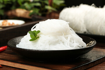 Longkou Bean Vermicelli Noodles from Shandong China in Traditional Bowl with Fresh Mint Garnish