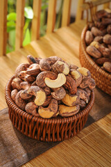 Roasted Cashew Nuts in Wicker Baskets on Wooden Table - Healthy Snack Food Ingredients
