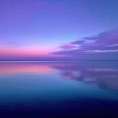 Fototapeta premium Serene twilight reflecting on a still lake. A tranquil scene of a calm lake mirroring a vibrant, colorful sunset sky of pinks, purples, and blues. Soft clouds are present near the horizon