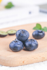 Fresh Big Blueberries on Wooden Board with Shallow Depth of Field - Healthy Organic Berry Fruit