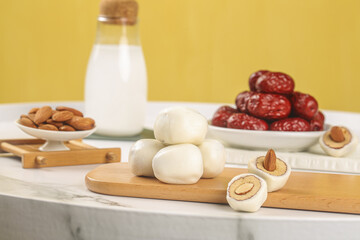 Handmade Date and Cheese Sandwich Snacks with Almonds and Milk on Wooden Board