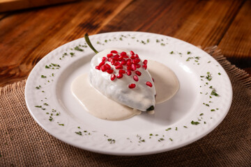 Chiles en Nogada, a typical Mexican dish. Poblano chile stuffed with meat and fruit, topped with a walnut, parsley, and pomegranate sauce. A tradition during Mexican national holidays.