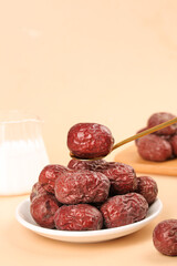 Xinjiang Red Dried Dates Jujube Fruit on Plate with Wooden Spoon Chinese Healthy Snack Food