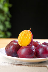 Sweet Xinjiang Prunes - Big Fresh Fruit on Plate with Golden Flesh Showing