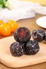 Xinjiang Tianshan Ume Mudi Preserves - Traditional Chinese Sweet Sour Dried Fruit on Wooden Board