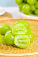 Fresh Green Grapes Cut in Half on Wooden Board - Healthy Organic Fruit Kitchen Scene