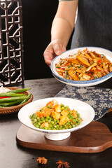 Sauteed Shrimp with Peas and Asian Noodle Dishes on Wooden Table with Traditional Chinese Decor