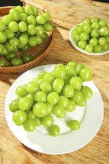 Fresh Green Seedless Grapes in Bowls on Wooden Table - Healthy Organic Fruit