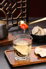Traditional Chinese herbal tea with goji berries and maca root healthy drink preparation