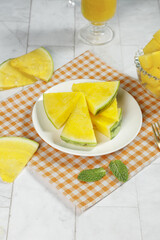 Yellow Watermelon Slices on White Plate with Orange Juice Summer Fresh Fruit Display