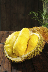 Fresh Thai Durian Fruit with Golden Flesh and Spiky Shell on Wooden Table