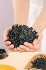 Dried Wakame Seaweed Kelp in Cupped Hands - Healthy Asian Superfood Ingredient