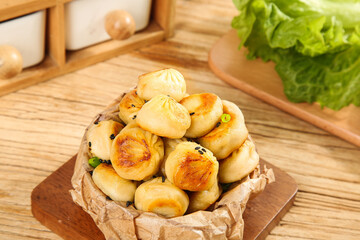 Golden Pan-Fried Buns with Sesame Seeds - Perfect Bite Size Breakfast Portion on Wooden Table