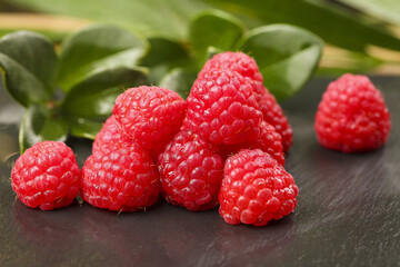 Fresh Red Raspberries on Dark Slate with Green Leaves - Healthy Berry Fruit Photography